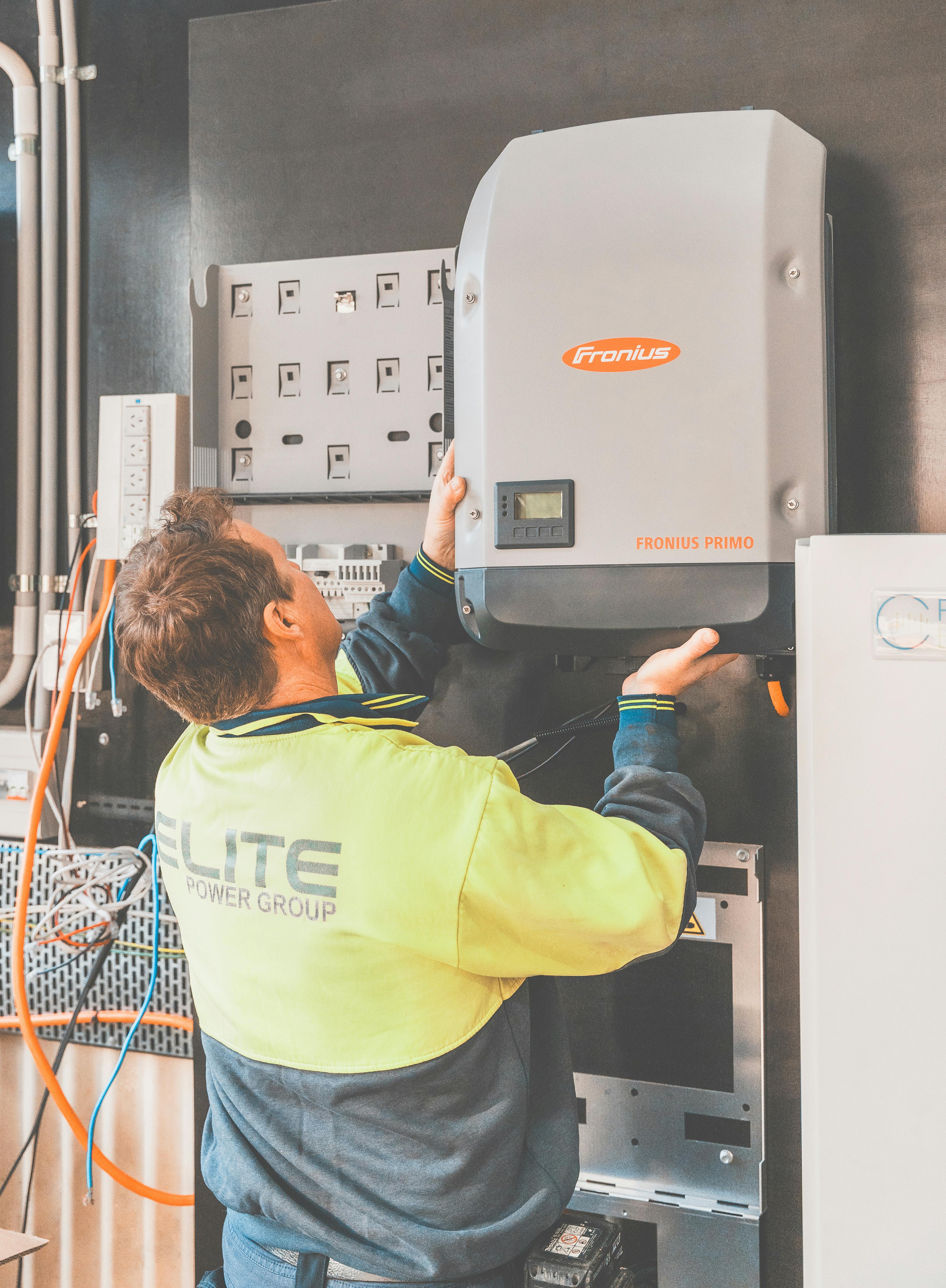 Electrician working on electrical panel installation