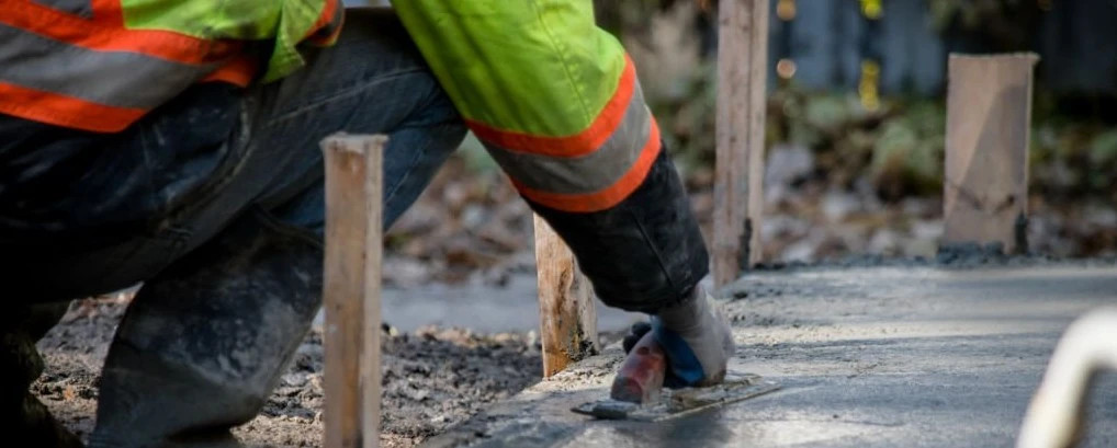 Construction worker in high-visibility gear working on site